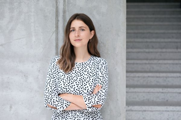 Woman against a grey wall